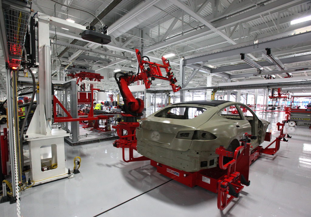 Robotic assembly machines use metrology to gauge distance from a car part it is moving.