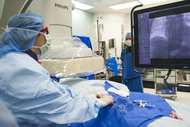 Surgeon viewing a screen displaying a patient's x-ray. People hope to use VR to replace these monitors.