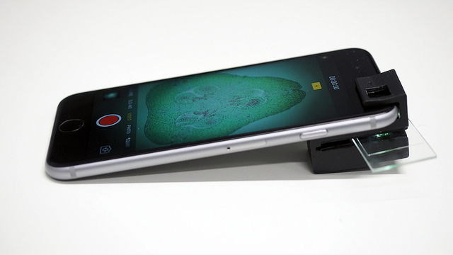 A clip attached to a smartphone to facilitate microscopy, as described in the previous paragraph.