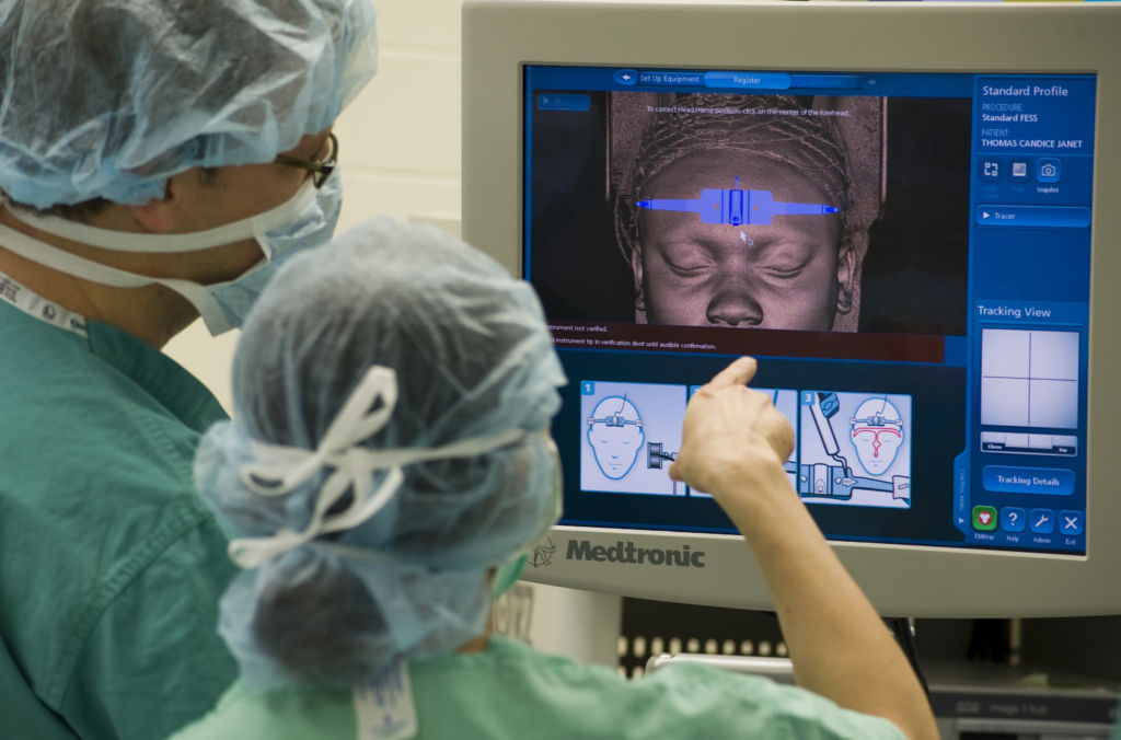 Surgeons use a CT scan of a patient's head to assist in diagnosis. Optical ultrasound could provide a real time image along with detailed CT scans.