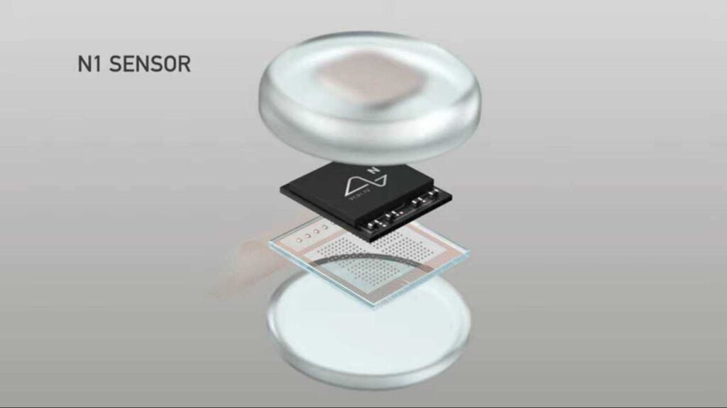 Close-up image of Neuralink's N1 Sensor chip, showing its compact, circular design and intricate circuitry.