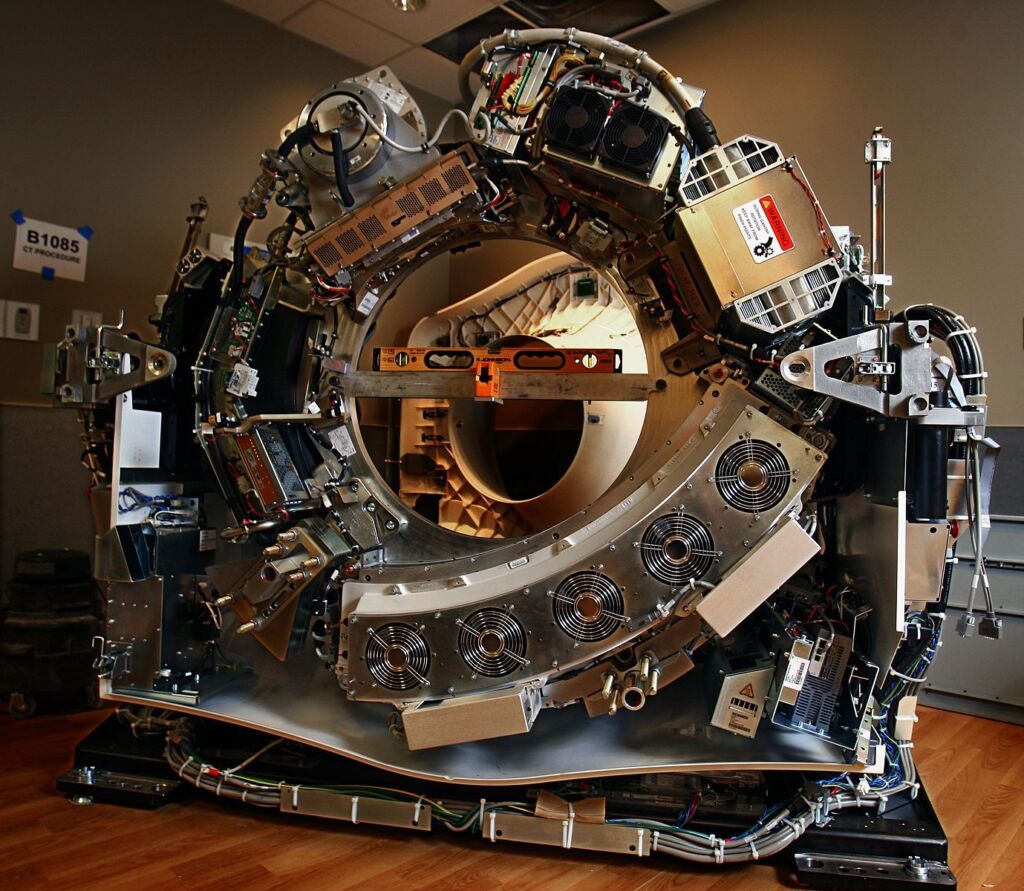 Close-up photo of a CT scanner's gantry, showcasing the circular opening where patients are scanned.
