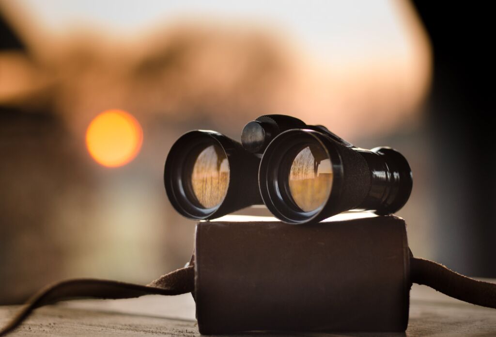 Binoculars focusing on the horizon, symbolizing targeted sales prospecting in high-tech industries.