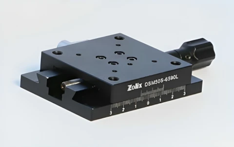 DSM Series aluminum dovetail linear stage with center-drive mechanism on a compact aluminum platform.
